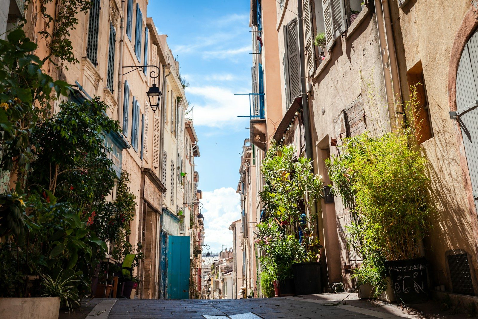 Photo by Andrei koscina cars parked on sidewalk in between buildings during daytime