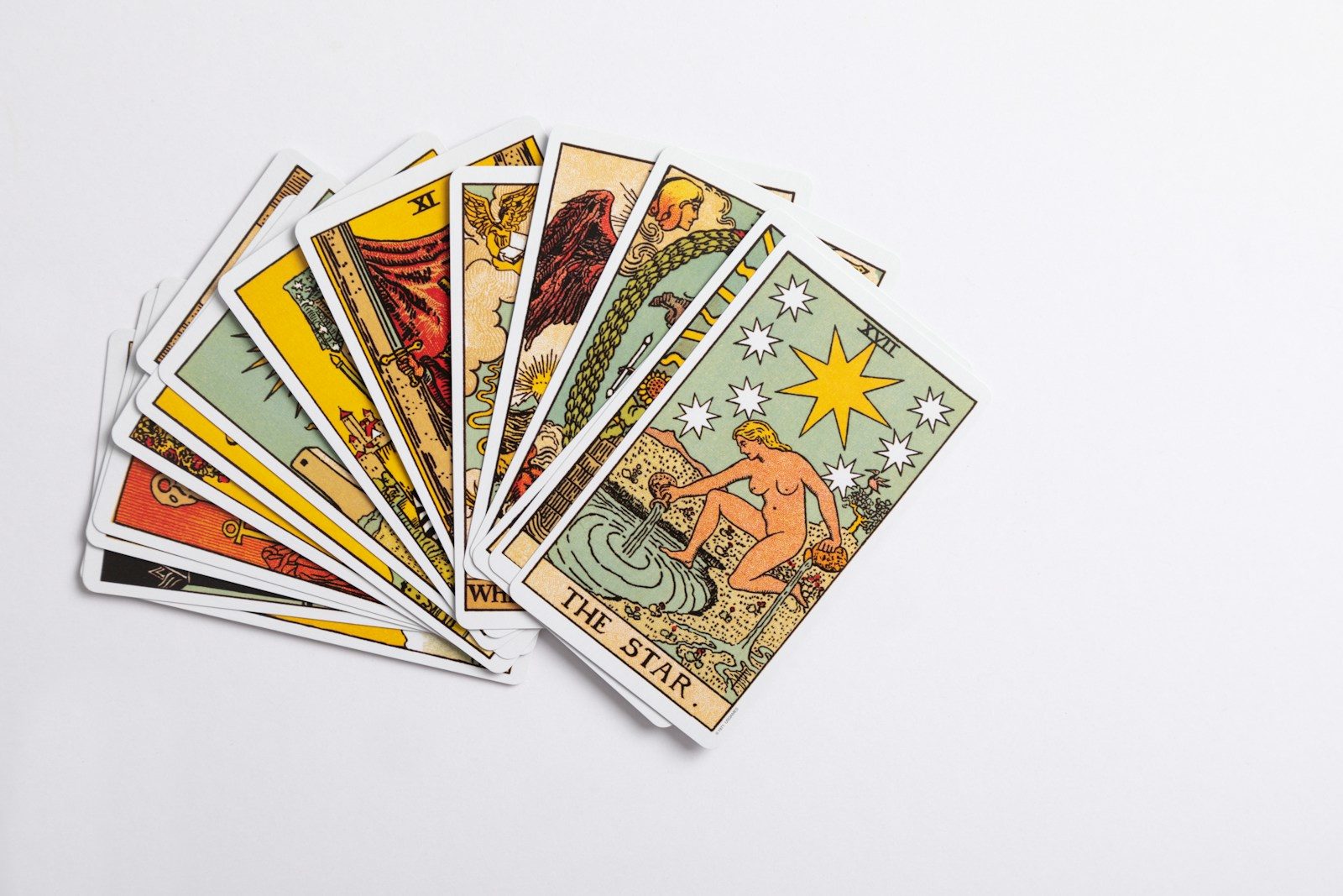 Photo by Viva Luna Studios a deck of tarot cards on a white surface